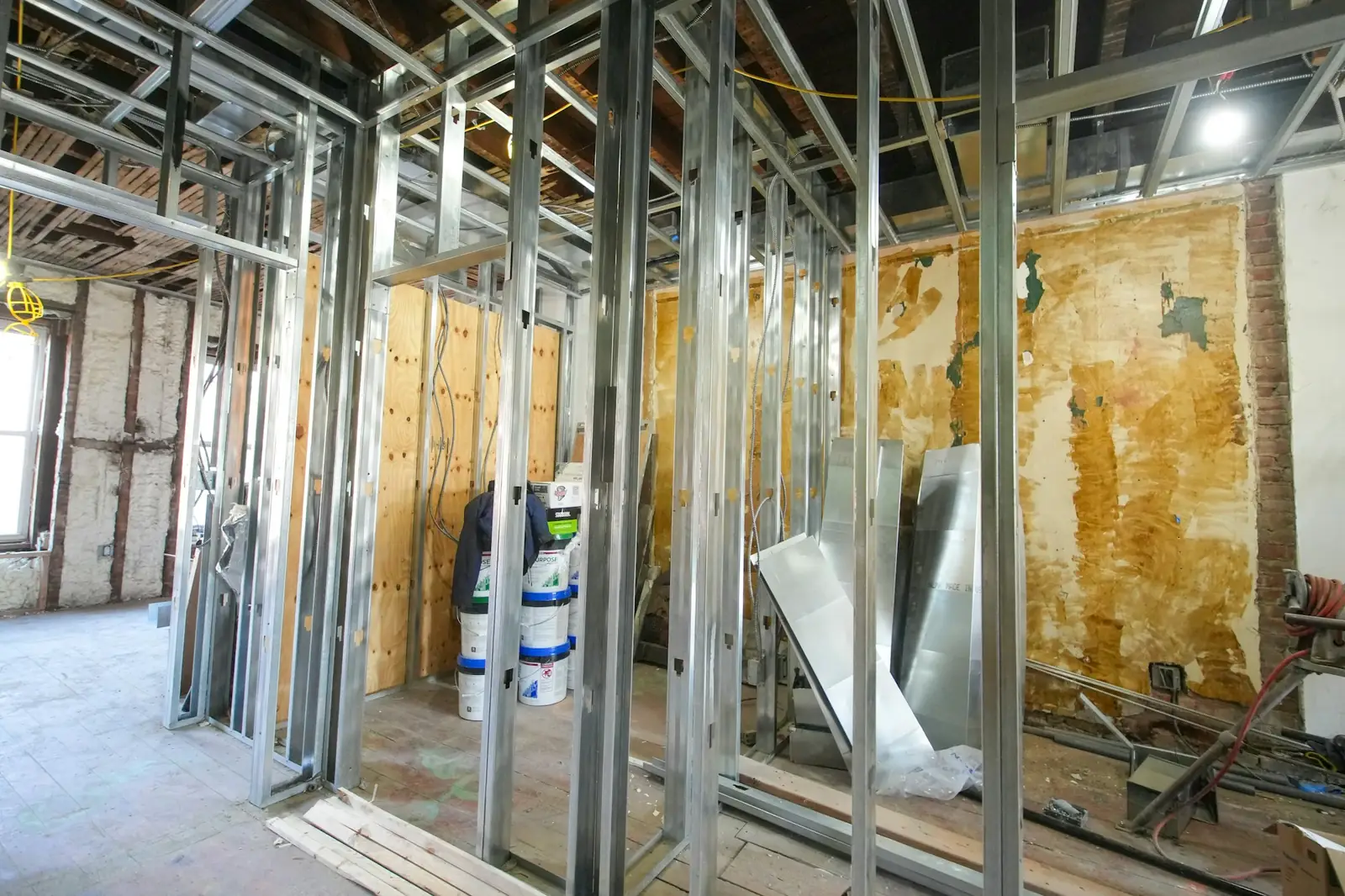 Commercial interior opened up to steel studs and exposed ceiling